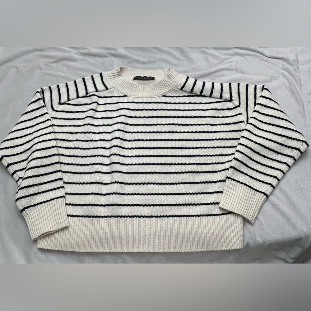 Women’s cropped black and cream sweater.